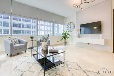 a living room with a glass coffee table and a tv at Gorgeous 1BR at Sky Gardens, DIFC by Deluxe Holiday Homes in Dubai