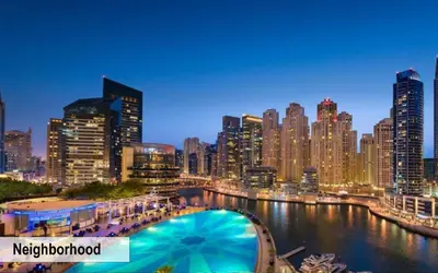 a view of a city at night with a pool at Luxury Escapes - Budget Studio with Balcony, Yacht Bay Marina in Dubai