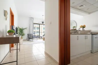 a kitchen and living room with white walls at Frank Porter - Al Thayyal 2, The Greens in Dubai