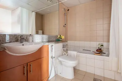 a bathroom with a sink and a toilet and a tub at Frank Porter - Al Thayyal 2, The Greens in Dubai