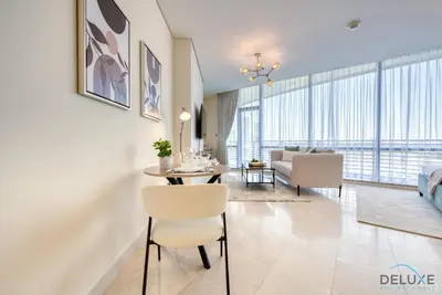 a living room with a table and chairs and a couch at Upscale Studio at Sky Gardens DIFC by Deluxe Holiday Homes in Dubai