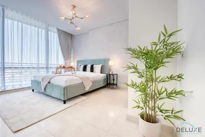 a bedroom with a bed and a potted plant at Upscale Studio at Sky Gardens DIFC by Deluxe Holiday Homes in Dubai