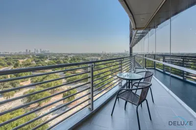 a balcony with two chairs and a table on a building at Upscale Studio at Sky Gardens DIFC by Deluxe Holiday Homes in Dubai