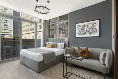 a bedroom with a bed and a couch at Silkhaus comfy furnished studio in the heart of DIFC in Dubai