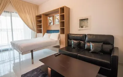 a bedroom with a bed and a couch and a table at Fully Furnished Studio, Ready to Move-in! Resortz 19 in Dubai