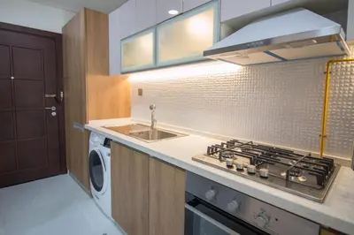 a small kitchen with a stove and a sink at Fully Furnished Studio, Ready to Move-in! Resortz 19 in Dubai