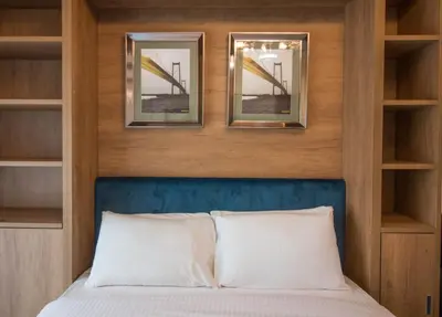 a bedroom with a bed with two mirrors above it at Fully Furnished Studio, Ready to Move-in! Resortz 19 in Dubai