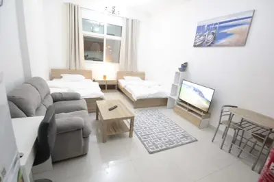 a living room with a couch and a table at Special Offer Studio for Rent in Dubai in Dubai