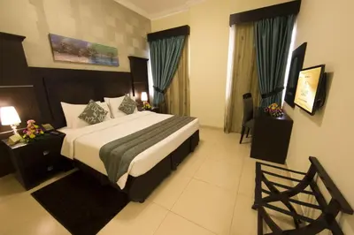 a bedroom with a large bed in a hotel room at Ivory Grand Hotel Apartments in Dubai
