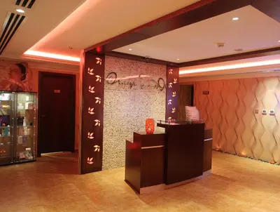 a lobby with a wall with asian writing on it at Ivory Grand Hotel Apartments in Dubai