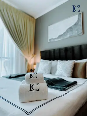 two towels sitting on top of a bed at Luxury Escapes - Modern Studio near Metro in X1 Tower JLT in Dubai
