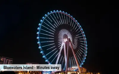 a large ferris wheel is lit up at night at Luxury Escapes - Modern Studio near Metro in X1 Tower JLT in Dubai