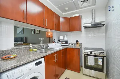 a kitchen with a sink and a dishwasher at Luxury Escapes - Modern Studio near Metro in X1 Tower JLT in Dubai