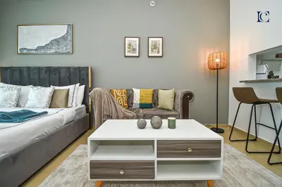 a living room with a couch and a coffee table at Luxury Escapes - Modern Studio near Metro in X1 Tower JLT in Dubai