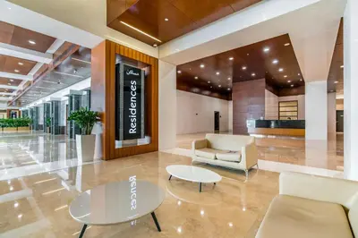 a lobby with a couch and a table and chairs at Silkhaus Dubai Financial Center studio in Burj Daman in Dubai