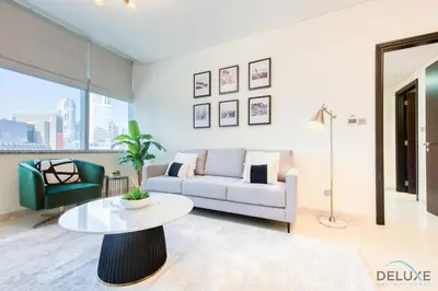 a living room with a couch and a table at Best Deal Elegant Studio with Balcony & Prime Location by Deluxe Holiday Homes in Dubai