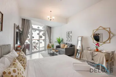 a bedroom with a bed and a living room at Intimate Studio at Millennium Binghatti Residence Business Bay by Deluxe Holiday Homes in Dubai