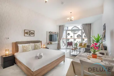 a bedroom with a large bed and a living room at Intimate Studio at Millennium Binghatti Residence Business Bay by Deluxe Holiday Homes in Dubai