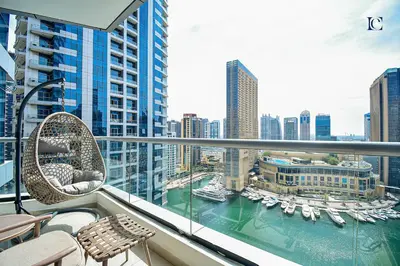 a balcony with chairs and a view of a harbor at Luxury Escapes - Marina Views 1BR Apartments - Bay Central Dubai Marina in Dubai