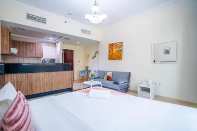 a living room with a bed and a kitchen at RH- Urban Living, Studio near Dubai Mall, Downtown in Dubai