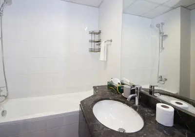 a bathroom with a sink and a bath tub at RH- Urban Living, Studio near Dubai Mall, Downtown in Dubai