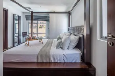 a bedroom with a large bed with white sheets and pillows at Frank Porter - Marina Promenade in Dubai