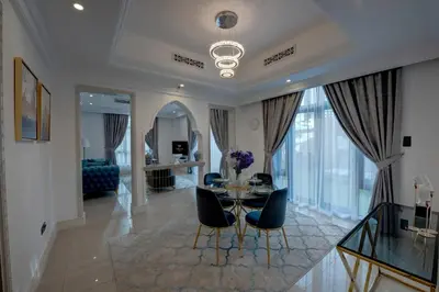 a living room with a glass table and chairs at Durrani Homes - Unique Garden Apt at Souk Al Bahar besides Dubai Mall & Burjkhalifa with private jaccuzi in Dubai