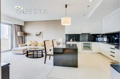a kitchen and living room with a couch and a table at Marina Mall Apartments, Dubai Marina in Dubai