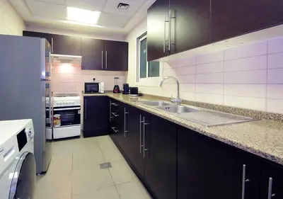 a kitchen with a sink and a refrigerator at RH- Cozy Studio, Al Waleed , Cluster R, JLT in Dubai