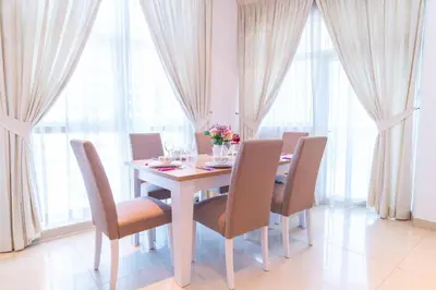 a dining room with a table and chairs and windows at Luxury Escapes - Spacious 2BR Apt in the heart of Dubai Marina- Yacht Bay in Dubai