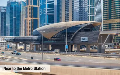 a metro station next to a highway in a city at Luxury Escapes - Modern Studio Apt - Metro, Beach & Mall mins away in Dubai