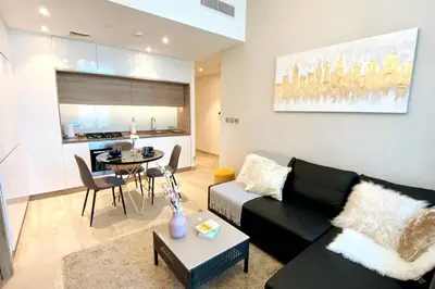 a living room with a black couch and a table at PROMO I Sea view I 1 BR apartment I Studio One Tower I Dubai Marina in Dubai