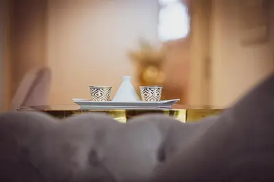 a table with three cups and a vase on a plate at Modern Dubai Hills Luxury 4 BEDROOM VILLA in Dubai