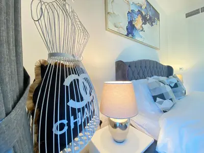 a large vase sitting on a table next to a bed at Modern Dubai Hills Luxury 4 BEDROOM VILLA in Dubai