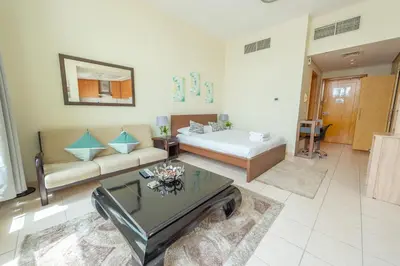 a living room with a bed and a couch at Luxury Escapes - Budget Studio Apt near Metro Stn - MOG184 DG in Dubai