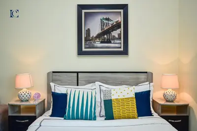 a bedroom with a bed with pillows and two lamps at Luxury Escapes - Cozy budget studio near Metro & Ibn Battuta Mall - MOG190 DG in Dubai