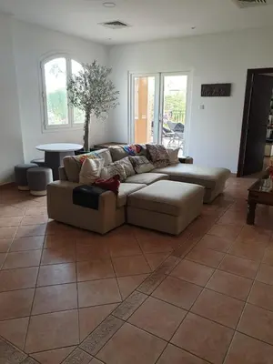 a living room with a couch on a tile floor at Cherrywood House in Dubai