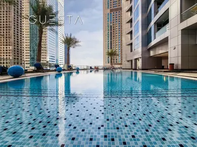 a swimming pool in a city with tall buildings at The Torch, Dubai Marina in Dubai