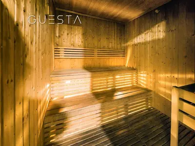 a wooden sauna with a sign that reads questica at The Torch, Dubai Marina in Dubai