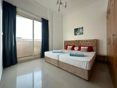 a bedroom with a bed and a large window at 2 BR apartment with a beautiful view of the Marina minimum 5 night in Dubai
