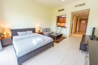 a bedroom with a bed and a living room at Luxury Escapes - Stylish Studio in DG near to Mall & Metro - KSLV in Dubai
