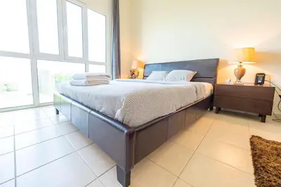 a large bed in a room with a large window at Luxury Escapes - Stylish Studio in DG near to Mall & Metro - KSLV in Dubai