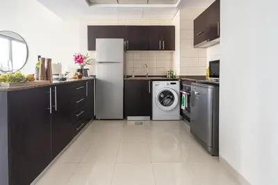 a kitchen with a refrigerator and a washing machine at Frank Porter - Bay Central in Dubai