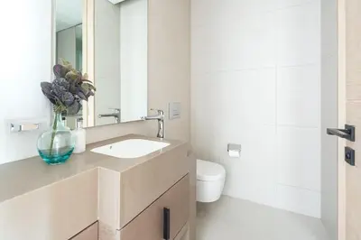 a bathroom with a sink and a toilet at Frank Porter - The Address JBR in Dubai