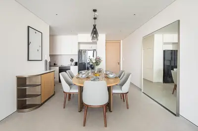 a kitchen and dining room with a table and chairs at Frank Porter - The Address JBR in Dubai