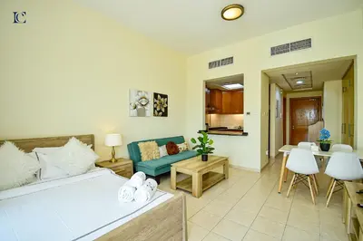 a living room with a bed and a dining room at Luxury Escapes - Tranquil Retreat - Studio Apts near Metro and Mall - Discovery Gardens - SHAR & MCL in Dubai