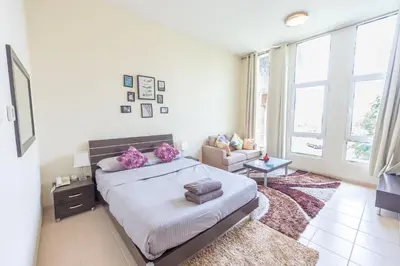 a bedroom with a bed and a living room at Luxury Escapes - Tranquil Retreat - Studio Apts near Metro and Mall - Discovery Gardens - SHAR & MCL in Dubai