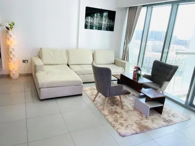 a living room with a couch and a table and chairs at Deluxe One Bedroom Apartment for rent in Dubai Al Barsha south in Dubai