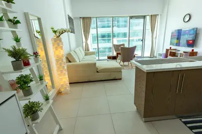 a living room with a couch and a table at Deluxe One Bedroom Apartment for rent in Dubai Al Barsha south in Dubai