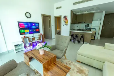 a living room with a couch and a table at Deluxe One Bedroom Apartment for rent in Dubai Al Barsha south in Dubai